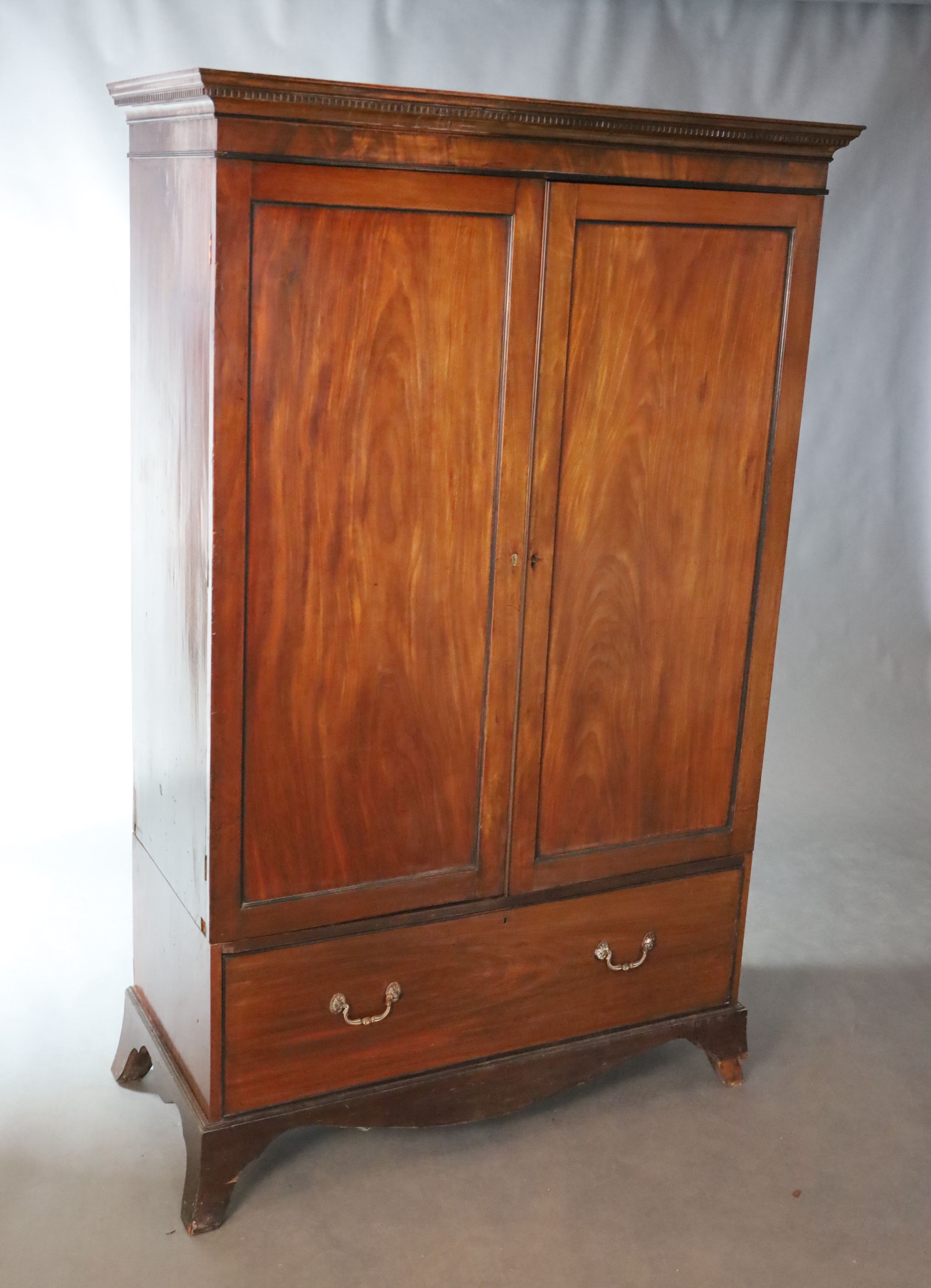 An early 19th century mahogany press cupboard, W.119.5cm D.54.5cm H.188cm
